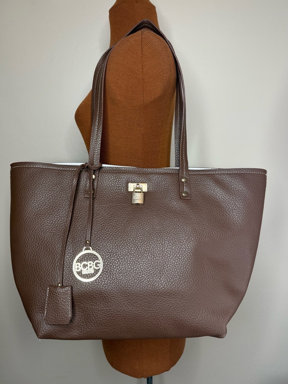 BCBG Dark Brown Pebbled Tote with Gold Lock Closure and Charm